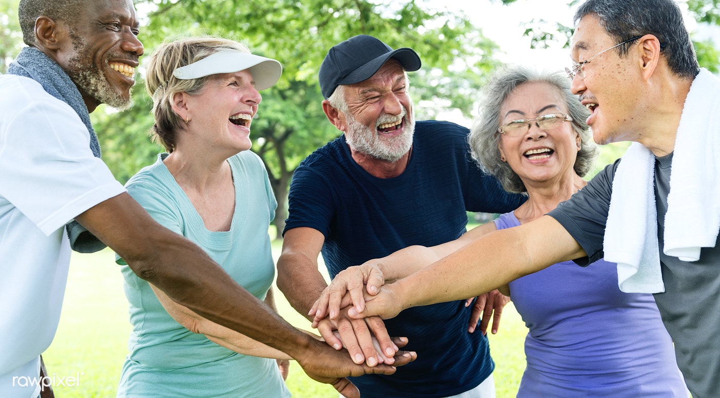 Diverse group of older adults with hands together